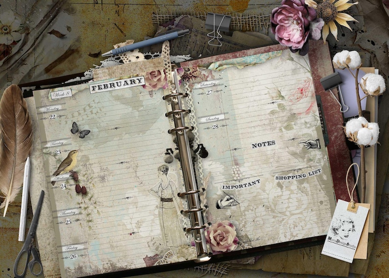 An open ring-bound planner with vintage-style pages labeled February, featuring illustrations of a bird, a butterfly, and a person. The pages include sections for notes, shopping lists, and important tasks, decorated with floral motifs and lace.
