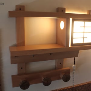 entryway organizer with shoji lamp, wooden coat rack with lamp, wooden frame with hanger shelves and lamp