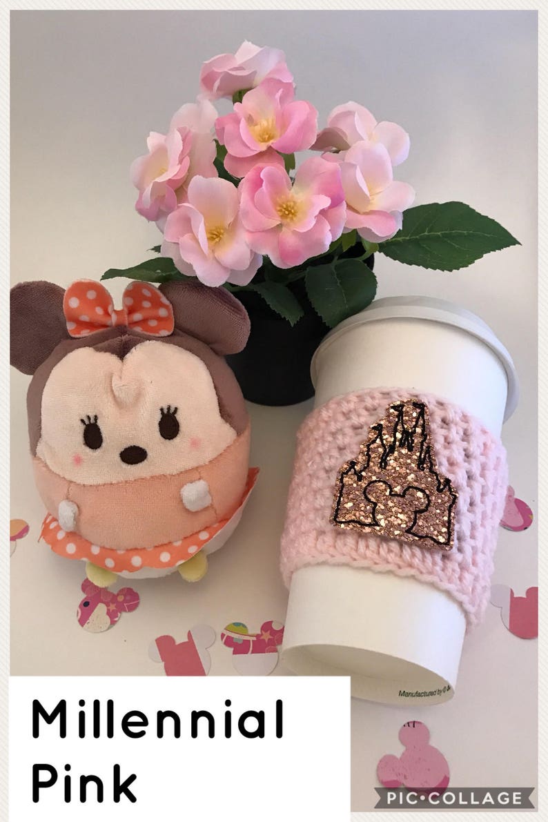 May include: Pink and white crocheted coffee cup cozy with a pink glitter castle and Mickey Mouse design.  The text "Millennial Pink" is at the bottom of the image.