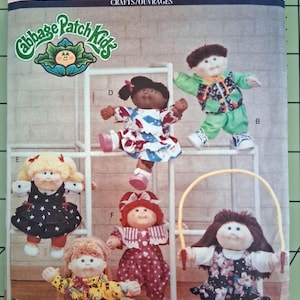 May include: A Butterick 5741 sewing pattern envelope for Cabbage Patch Kids dolls. The cover features six dolls in various outfits, including a yellow patterned shirt, a green tracksuit, a floral romper, a star-print dress, and a polka-dot dress.