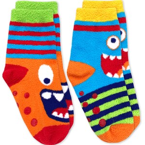 May include: A pair of colorful fuzzy socks with monster faces. One sock is orange with blue stripes and a red mouth. The other sock is blue with green stripes and a yellow mouth.