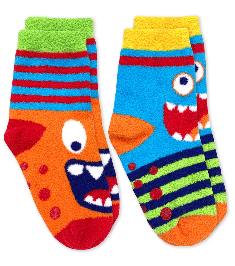 May include: A pair of colorful fuzzy socks with monster faces. One sock is orange with blue stripes and a red mouth. The other sock is blue with green stripes and a yellow mouth.