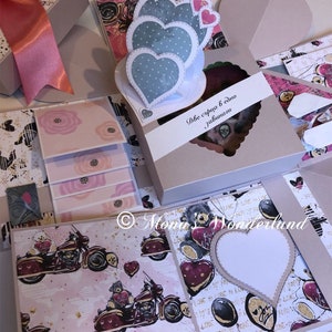 May include: A handmade explosion box with a pink bow, featuring heart-shaped decorations and a motorcycle pattern. The box includes a heart-shaped window and the text "Две сърца в едно завинаги".