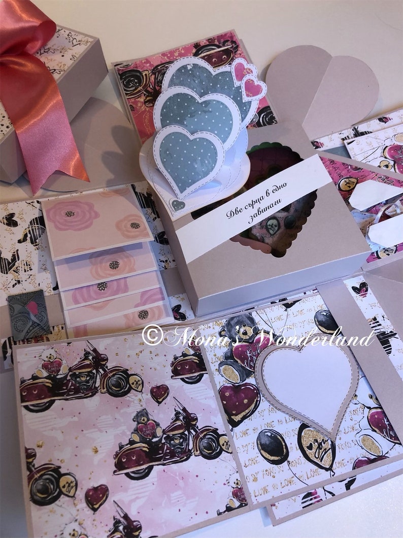 May include: A handmade explosion box with a pink bow, featuring heart-shaped decorations and a motorcycle pattern. The box includes a heart-shaped window and the text "Две сърца в едно завинаги".