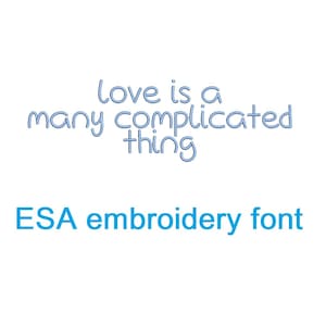 May include: Blue text on a white background reads "love is a many complicated thing". Below the text is the phrase "ESA embroidery font" in blue.
