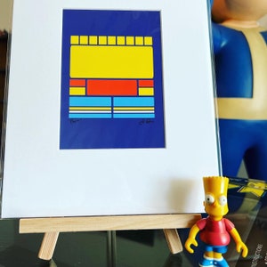 May include: A framed abstract geometric art print with a yellow, red, blue, and white color scheme. The print is on a blue background and is titled "Bert".