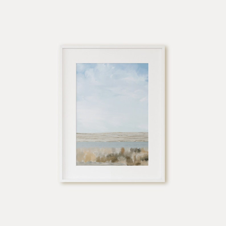 May include: A framed painting of a landscape with a blue sky, white clouds, and a body of water in the distance. The foreground is a field of brown and green grasses.