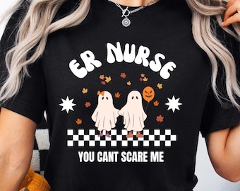 Könnte beinhalten: Schwarzes T-Shirt mit dem Text "ER NURSE" in weißen Buchstaben mit einem Geistermotiv und dem Text "YOU CAN'T SCARE ME" in weißen Buchstaben.