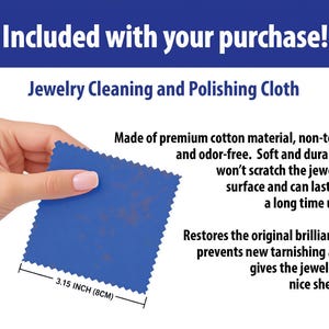 a hand holding a piece of blue fabric, which appears to be a cleaning and polishing cloth. The text above the image states that the cloth is included with the purchase, and it is made of premium cotton material, non-toxic, and odor-free. The cloth is described as soft and durable, and it won't scratch the jewelry surface and can last for a long time. The image also mentions that the cloth is 3.15 inches (8.4 cm) in size.