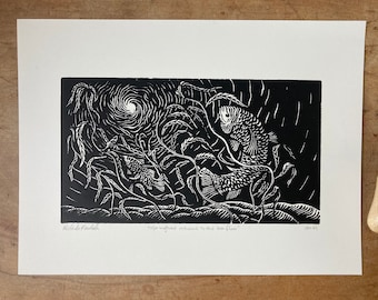 May include: A black and white linocut print titled "Springtime returns to the sea floor" featuring two fish swimming among seaweed. A carving tool with a wooden handle and black blade is to the right of the print.