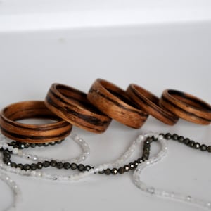 Holzring, Ehering, gebogener Holzring, Hochzeit, gebogene Holzringe, Zebrano-Ring, personalisierter Ring.  Hochzeit aus Holz