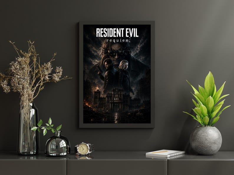 May include: A framed rectangular wall poster featuring the text RESIDENT EVIL requiem. The artwork displays two figures standing back-to-back in front of a dark, gothic building under a stormy sky, with a large, shadowy face looming above them.