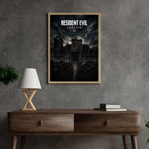 Op de afbeelding: Een ingelijste poster met de titel "RESIDENT EVIL: Requiem" tegen een donkere, stormachtige achtergrond. Het kunstwerk toont een vervallen gebouw. De poster wordt weergegeven op een houten console met een lamp en groen.