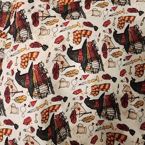 May include: A cream-colored fabric with a repeating pattern of illustrations. The design includes images of books, scarves, keys, feathers, and other magical elements in shades of red, gold, and black. The overall theme suggests a fantasy or wizarding world.