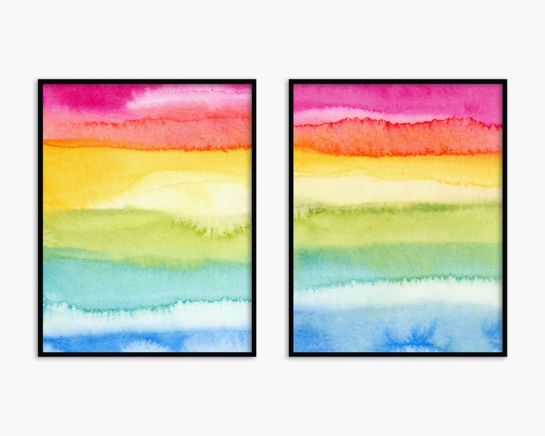 May include: Two framed watercolour paintings with a rainbow colour scheme. The paintings feature horizontal stripes of pink, orange, yellow, green, blue, and light blue.