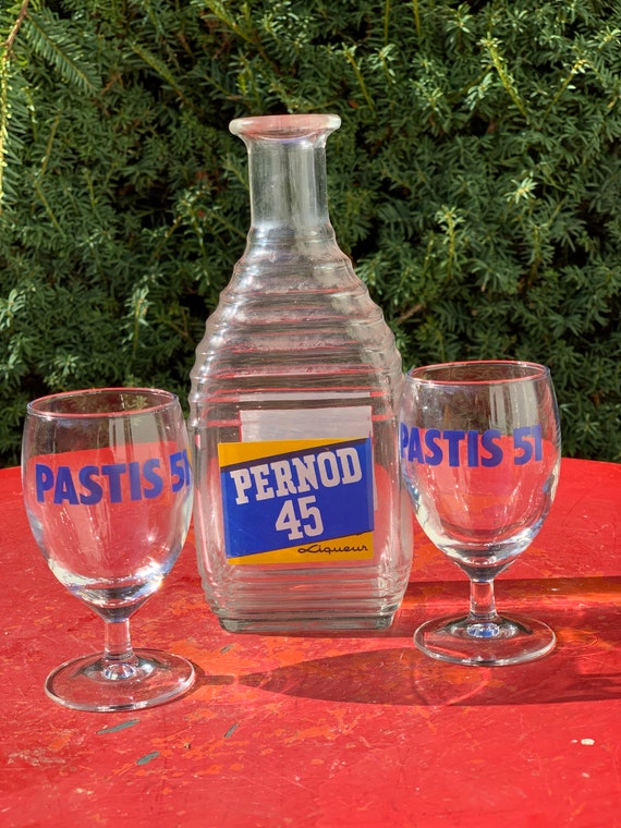 A bottle of Ricard 45 pastis and a glass and a carafe of water on