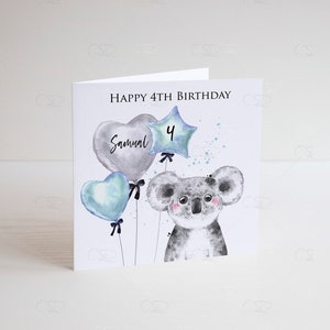 May include: A white card with a watercolor illustration of a koala holding blue and gray balloons. The balloons have the text "Samuel" and the number "4" on them. The card reads "Happy 4th Birthday".