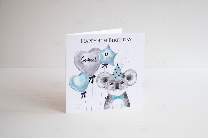 May include: A birthday card featuring a cute koala wearing a party hat and holding balloons. The balloons are blue, gray, and star-shaped with the number "4" and the name "Samuel" written on them. The card says "Happy 4th Birthday".