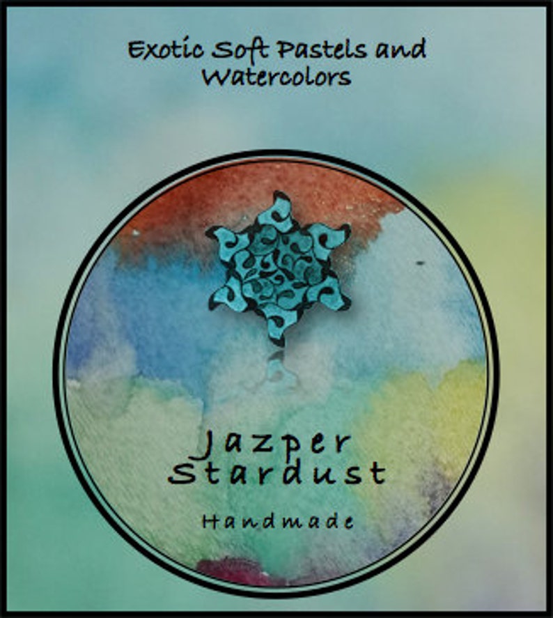 May include: A teal blue and black starburst design with a white background. The design is surrounded by a circle of watercolor washes in shades of orange, yellow, green, and blue. The text "Jazper Stardust Handmade" is written below the design.