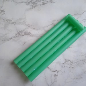 May include: A set of five green inflatable pool floats, stacked together in a rectangular shape.