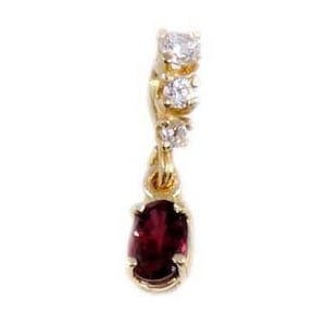 May include: A gold pendant with a red gemstone and small clear gemstones.