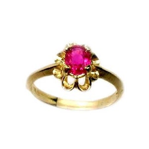 May include: A gold ring with a red ruby gemstone set in a floral design.