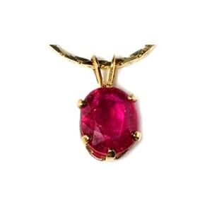 May include: A gold pendant necklace with a large, oval, deep red gemstone. The gemstone is set in a gold bezel with four prongs. The chain is a delicate gold link.