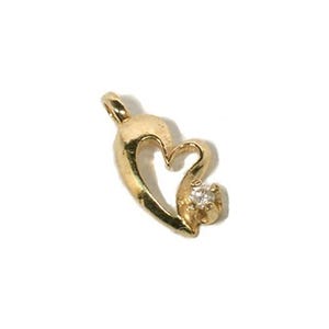 May include: A gold-colored heart pendant with a small, clear gemstone. The pendant has a loop at the top for a chain and a curved, open heart design. The gemstone is set at the bottom of the heart.