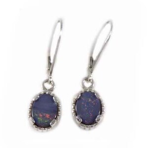 May include: A pair of silver dangle earrings with oval-shaped black opal gemstones set in a silver bezel.