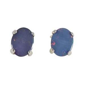 May include: A pair of oval-shaped stud earrings. Each earring features a dark blue gemstone with flecks of red and is set in a silver-colored metal. The earrings are displayed against a white background.