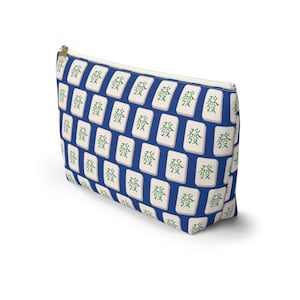 May include: A blue and white zippered pouch with a repeating pattern of white mahjong tiles with green Chinese characters that say "發" (pronounced "fa") which means "prosperity" in English.