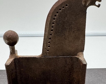 May include: A rustic brown cast iron horse sculpture with a rounded head and a tail that ends in a ball. The horse has four legs and a simple design.