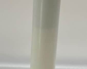 May include: A brass pineapple-shaped candle lamp base featuring a textured, cross-hatched surface and a leafy top rim. A tall, white cylindrical candle sleeve is inserted into the center, topped with a clear, flame-shaped electric light bulb.