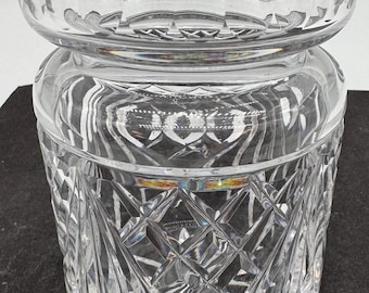 May include: A clear glass vase with a diamond pattern. The vase has a wide mouth and a narrow base.
