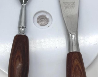 May include: A carving fork and knife set with stainless steel blades and dark wood handles. The knife blade has the text "robin danish STAINLESS SHEFFIELD ENGLAND". The set is on a white surface.