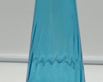 May include: A tall, blue glass vase with a wide base and a narrow neck. The vase has a textured, rippled surface.
