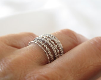 Filigree multi-row ring in rhodium-plated solid 925 sterling silver and adorned with set cubic zirconias