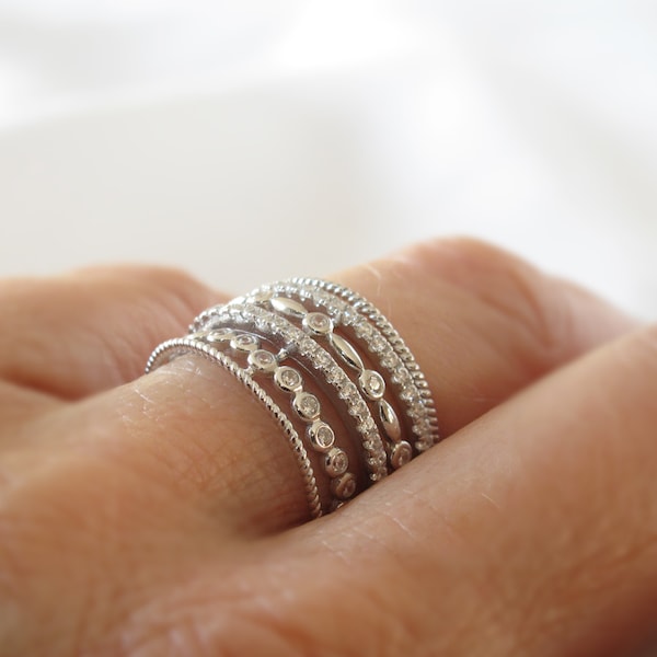 Filigree multi-row ring in rhodium-plated solid 925 sterling silver and adorned with set cubic zirconias