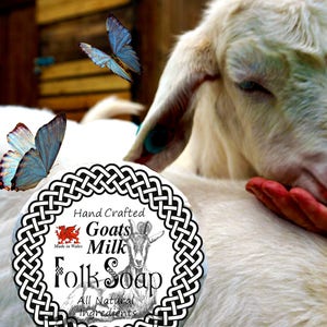 May include: A white goat with a black and white Celtic knot design around a label that reads "Hand Crafted Goats Milk Folk Soap All Natural Ingredients". The goat is looking down at a hand, and there are blue butterflies flying around the goat.