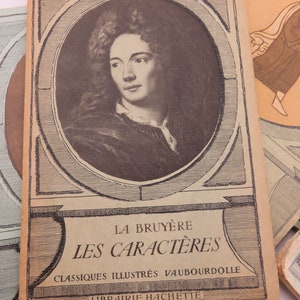 May include: A vintage book cover featuring a portrait of a man with long curly hair. The title is "La Bruy&egrave;re Les Caract&egrave;res" with the text "Classiques Illustr&eacute;s Vaubourdolle Librairie Hachette" below.