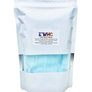 May include: A white pouch of K'MHC Flake Away Wipes. The pouch has a clear window revealing a stack of light blue wipes. The product label includes directions and ingredients. The wipes are designed for flaky skin and scalp.