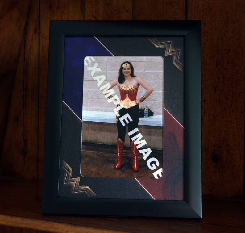 Black frame with a professionally printed 2 inch Mount to fit a 6 x 4 Inch photo. Wonder Woman Style Picture Frame