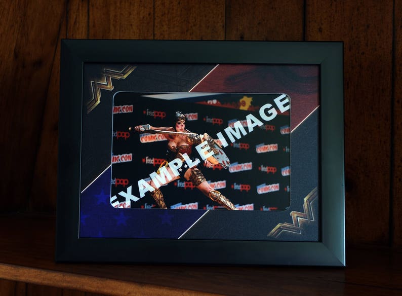 Black frame with a professionally printed 2 inch Mount to fit a 6 x 4 Inch photo. Wonder Woman Style Picture Frame