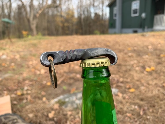 312 favorites for a forged iron keychain opener that's priced under $20 — high demand signal at an impulse-buy price point for genuine blacksmith work.