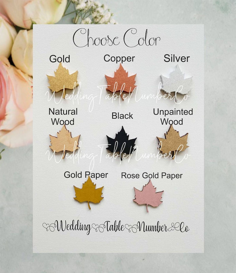 May include: Choose a color for your wedding table number: gold, copper, silver, natural wood, black, unpainted wood, gold paper, or rose gold paper. The table numbers are shaped like maple leaves.