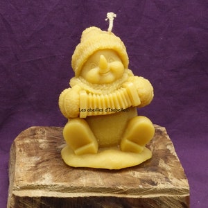 candle snowman playing the accordion