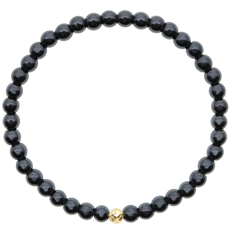 May include: A black beaded bracelet with a single gold bead.