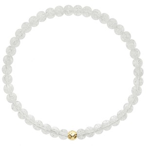 May include: A white crystal beaded bracelet with a gold bead accent. The bracelet is made of small, round beads and is strung on a clear elastic cord.