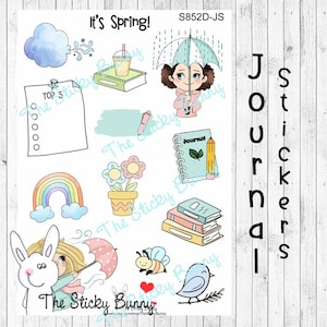 Può includere: Un foglio di adesivi a tema primaverile, con illustrazioni di una ragazza con un ombrello, un arcobaleno, fiori, un coniglietto e il testo "It's Spring!" e "Journal Stickers".