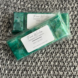 May include: Two packs of green and white soy wax melts with the text "Four Wicks Handmade Soy Candles Sinus Relief www.fourwickssoycandles.com" on the front.